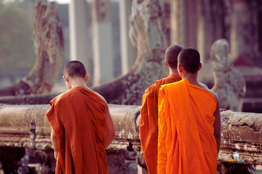 Buddhist monks walking inside ancient temple in Laos – Auasia Travel